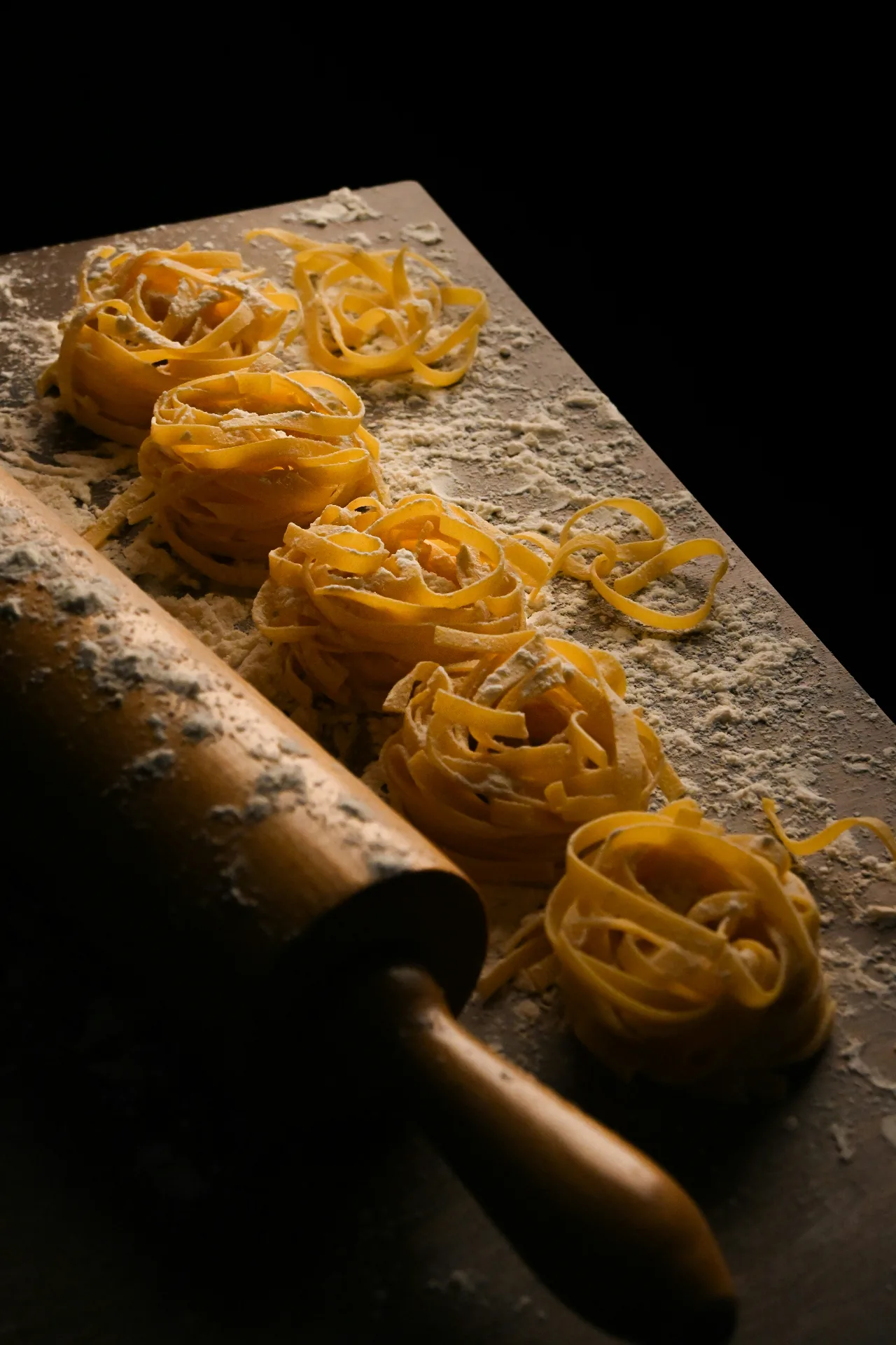 Fresh handmade pasta with rolling pin